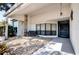 Inviting front porch with stone accents, decorative plants, and a cozy seating area at 8979 Hernando Way, Weeki Wachee, FL 34613