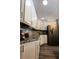 Corner view of kitchen featuring granite countertops, stainless steel appliances, and wood flooring at 8979 Hernando Way, Weeki Wachee, FL 34613