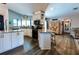 Bright kitchen features granite countertops, white cabinetry, stainless steel appliances, and wood-look floors at 8979 Hernando Way, Weeki Wachee, FL 34613