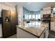 Modern kitchen with stainless steel appliances, granite countertops, and a large island at 8979 Hernando Way, Weeki Wachee, FL 34613
