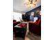 Cozy living room showcasing dark accent wall, wood-look floors, and comfortable seating arrangement at 8979 Hernando Way, Weeki Wachee, FL 34613