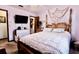 Cozy bedroom with a relaxed atmosphere, features light purple walls, a soft bed, and ample natural light at 8979 Hernando Way, Weeki Wachee, FL 34613