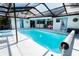 Relaxing pool area with a screened enclosure, offering both sun and shade for comfortable outdoor living at 8979 Hernando Way, Weeki Wachee, FL 34613