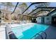 Inviting backyard oasis with a screened pool, lush landscaping, and ample space for outdoor activities at 8979 Hernando Way, Weeki Wachee, FL 34613
