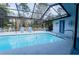 Beautiful screened-in pool area with ample seating, perfect for outdoor relaxation and entertainment at 8979 Hernando Way, Weeki Wachee, FL 34613
