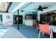 Charming outdoor patio with a covered bar and seating area located next to the sparkling pool at 8979 Hernando Way, Weeki Wachee, FL 34613