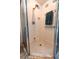 Shower with white tile and silver fixtures at 8979 Hernando Way, Weeki Wachee, FL 34613