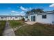 Cozy backyard patio area with lush greenery and a well-maintained lawn at 10022 Lily N St # N, Pinellas Park, FL 33782