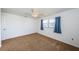 Bedroom featuring carpet, one window with curtains and a ceiling fan at 10022 Lily N St # N, Pinellas Park, FL 33782