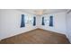 Bedroom featuring carpet, ceiling fan, two windows with curtains and a closet at 10022 Lily N St # N, Pinellas Park, FL 33782