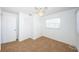 A bright and airy bedroom with neutral carpet, ceiling fan and closet provides a simple, yet comfortable space at 10022 Lily N St # N, Pinellas Park, FL 33782