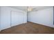 Bedroom features carpet, a closet with sliding doors, and a ceiling fan at 10022 Lily N St # N, Pinellas Park, FL 33782