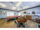 Game room featuring a pool table, tables, and board games, ideal for recreational activities and socializing at 10022 Lily N St # N, Pinellas Park, FL 33782