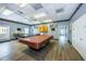 Bright game room featuring a pool table, tables, trophies, and a bingo closet for community fun at 10022 Lily N St # N, Pinellas Park, FL 33782