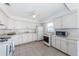 Bright and clean kitchen featuring tiled floors, white cabinets, and modern appliances at 10022 Lily N St # N, Pinellas Park, FL 33782