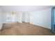 Spacious living room with neutral carpeting and ample natural light, ready for personalization and comfortable living at 10022 Lily N St # N, Pinellas Park, FL 33782
