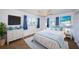 Main bedroom featuring blue accents, two windows, carpet and ceiling fan at 10022 Lily N St # N, Pinellas Park, FL 33782
