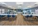Spacious meeting room with tables, chairs, a stage and wood flooring, perfect for gatherings at 10022 Lily N St # N, Pinellas Park, FL 33782