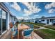 Outdoor patio area has a dining table and a view of a well-maintained lawn and the community at 10022 Lily N St # N, Pinellas Park, FL 33782