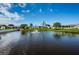Pond view features a water fountain, surrounding landscaping and nearby building exteriors at 10022 Lily N St # N, Pinellas Park, FL 33782