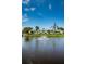 Pond view featuring a water fountain, surrounding landscaping and nearby building exteriors at 10022 Lily N St # N, Pinellas Park, FL 33782