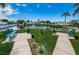 Lush pond features mature landscaping, a fountain, and benches for relaxing by the water at 10022 Lily N St # N, Pinellas Park, FL 33782