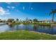 Scenic pond view features lush landscaping, a fountain, and the exterior of the neighboring homes at 10022 Lily N St # N, Pinellas Park, FL 33782