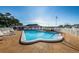 A pristine outdoor pool area with plenty of seating and sunbathing space at 10022 Lily N St # N, Pinellas Park, FL 33782