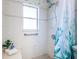 Close up of the tiled shower featuring a bench seat and grab bar at 10022 Lily N St # N, Pinellas Park, FL 33782