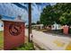 Neighborhood entrance featuring brick signage, surrounding neighborhood watch and mature landscaping at 10022 Lily N St # N, Pinellas Park, FL 33782