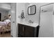 Bathroom featuring a dark cabinet vanity, framed mirror and a door leading to the shower at 10263 Gandy N Blvd # 209, St Petersburg, FL 33702