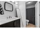 This bathroom features a sink, white countertop, dark cabinetry and a framed mirror at 10263 Gandy N Blvd # 209, St Petersburg, FL 33702