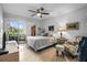A bright bedroom features tile floors, ceiling fan and sliding glass doors leading to the patio at 10263 Gandy N Blvd # 209, St Petersburg, FL 33702