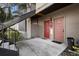 Building exterior with two entry doors, stairwell and landscaped area at 10263 Gandy N Blvd # 209, St Petersburg, FL 33702