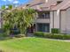 Well-maintained condo with a patio, lush lawn, and manicured hedges at 10263 Gandy N Blvd # 209, St Petersburg, FL 33702