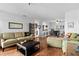 A bright living room with wood floors, open to the kitchen, and tastefully furnished with comfortable seating at 10263 Gandy N Blvd # 209, St Petersburg, FL 33702