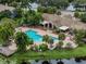 Beautiful community pool with mature landscaping, brick pavers, and lake views at 10263 Gandy N Blvd # 209, St Petersburg, FL 33702