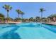 Stunning blue pool with lounge chairs and palm trees at 10263 Gandy N Blvd # 209, St Petersburg, FL 33702