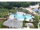 Aerial view of a community featuring an inviting pool, playground, and a sandy beach on the lake at 11008 Tahiti Isle Ln, Tampa, FL 33647