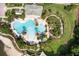 Aerial shot of an outdoor pool, lounge area, and water park with palm trees at 11008 Tahiti Isle Ln, Tampa, FL 33647