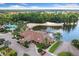 Aerial view showcasing the Beach Club, lakefront access, playground, and pool amidst lush surroundings at 11008 Tahiti Isle Ln, Tampa, FL 33647