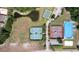 Aerial view of community recreational area featuring tennis, basketball, and skating rinks, pond, and green spaces at 11008 Tahiti Isle Ln, Tampa, FL 33647
