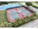 Overhead view of well-maintained tennis courts and ice rink surrounded by lush landscaping at 11008 Tahiti Isle Ln, Tampa, FL 33647