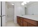 Bright bathroom featuring a vanity with wood cabinets, a white countertop, and a shower-tub combo at 11008 Tahiti Isle Ln, Tampa, FL 33647