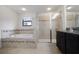 Modern bathroom with soaking tub, glass shower, and dark wood vanity at 11008 Tahiti Isle Ln, Tampa, FL 33647