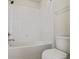 A well-lit bathroom boasts a clean white tiled shower over tub with toilet at 11008 Tahiti Isle Ln, Tampa, FL 33647