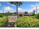 Inviting Beach Club entrance featuring manicured landscaping and a picturesque facade under a clear blue sky at 11008 Tahiti Isle Ln, Tampa, FL 33647