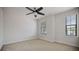 Bedroom with two windows and a ceiling fan at 11008 Tahiti Isle Ln, Tampa, FL 33647