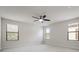 Spacious bedroom with ceiling fan and three windows offering natural light at 11008 Tahiti Isle Ln, Tampa, FL 33647