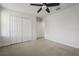 Spacious bedroom with plush carpeting, ceiling fan, and ample closet space at 11008 Tahiti Isle Ln, Tampa, FL 33647
